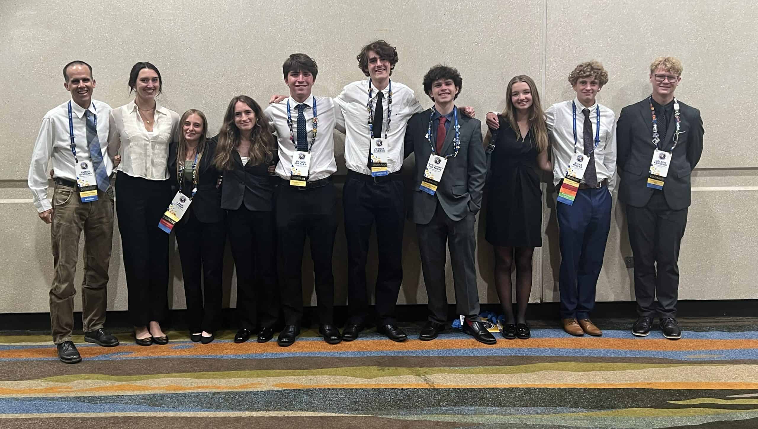 10 FBLA students from Longmont High standing in a row posing for the photo with their teacher on the left.